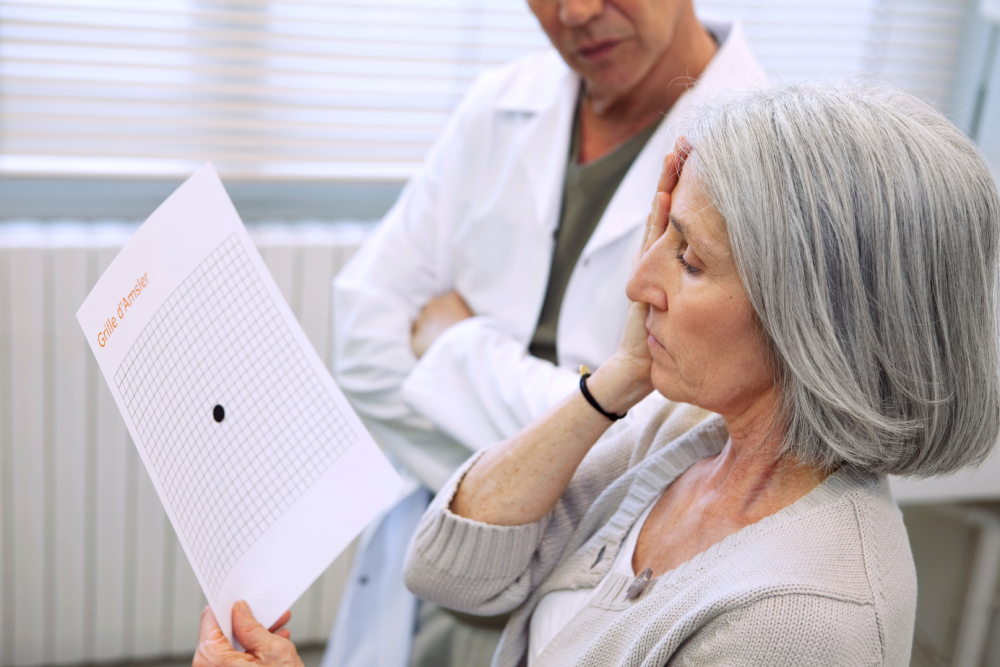 Treatment and Management Based on Findings An older woman covers one eye while holding an Amsler grid, as a healthcare professional observes, likely during an eye exam.