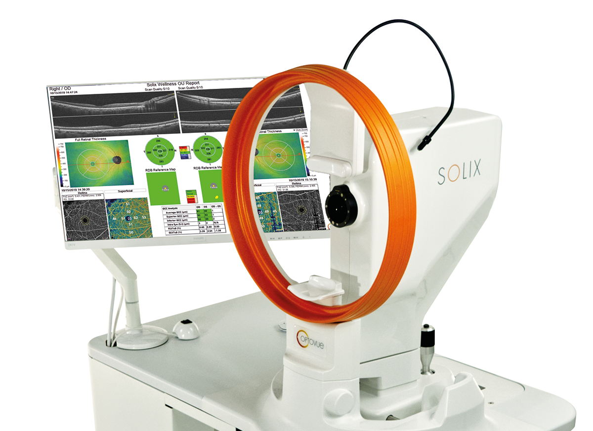A Solix eye imaging device with an orange ring is positioned next to a monitor displaying eye scan results and diagnostic data.